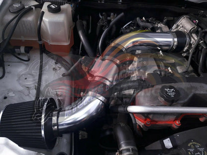 Rtunes Racing polished chrome cold air intake kit with black conical filter installed in a 3.7L engine bay.